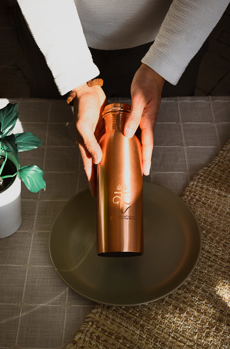 Hand holding Jala pure copper water bottle - for Tamra Jal morning ritual, Tatva Krti Canada